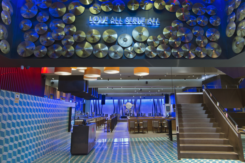 Entrance of a restaurant in Tenerife with records and the phrase Love All Serve All.