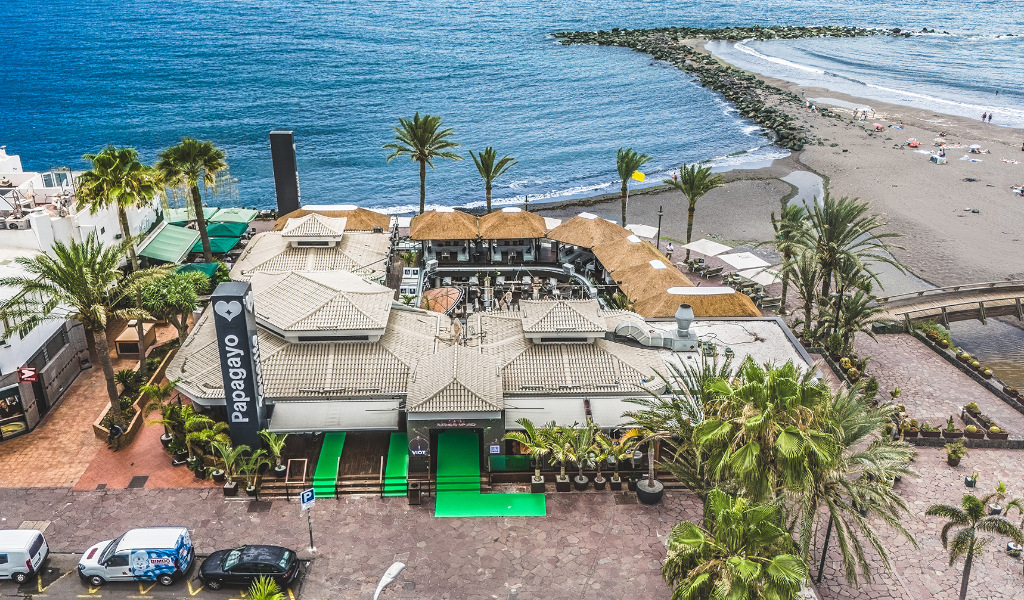 Aerial view of a coastal restaurant in Tenerife by the beach and the ocean.