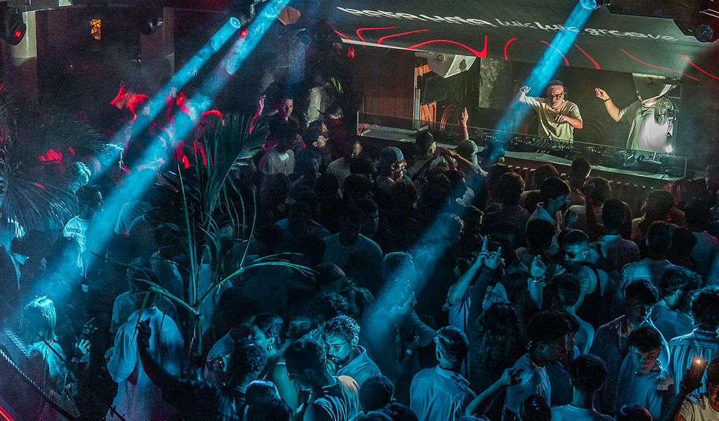 Crowd enjoying a DJ in a nightclub in Tenerife.