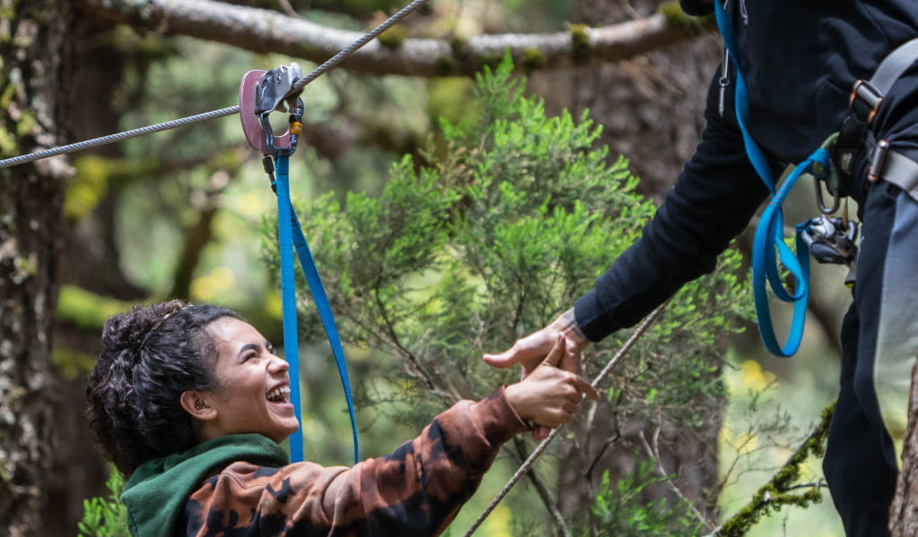 Person laughing while ziplining in a forest in Tenerife.