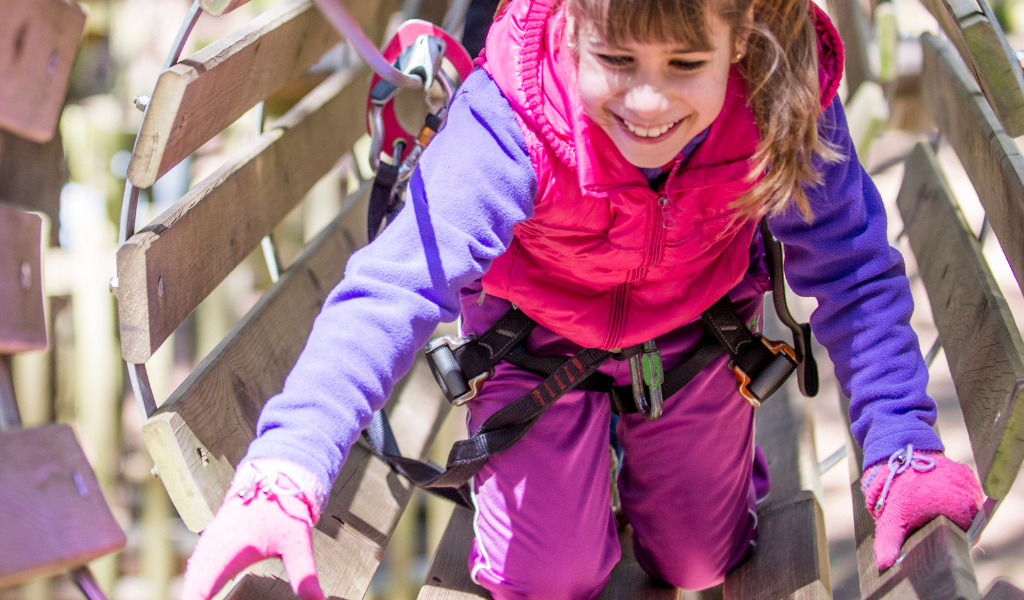 Little girl climbing in adventure park in Tenerife.