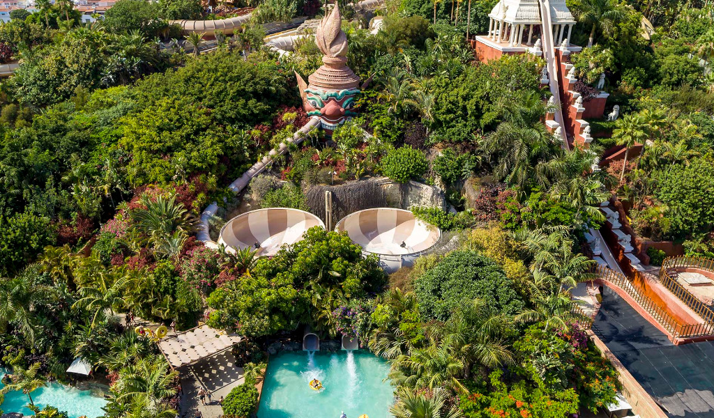 Aerial view of the Siam Park water park in Tenerife with slides and lush vegetation.