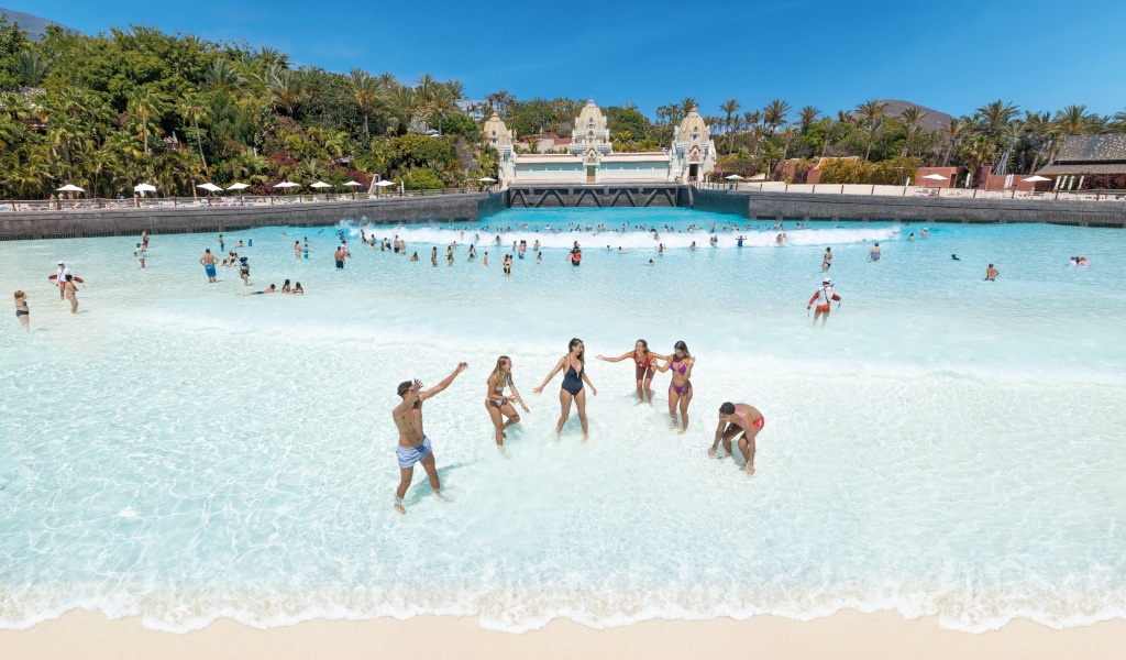 People enjoying the pool with waves in Siam Park, Tenerife.