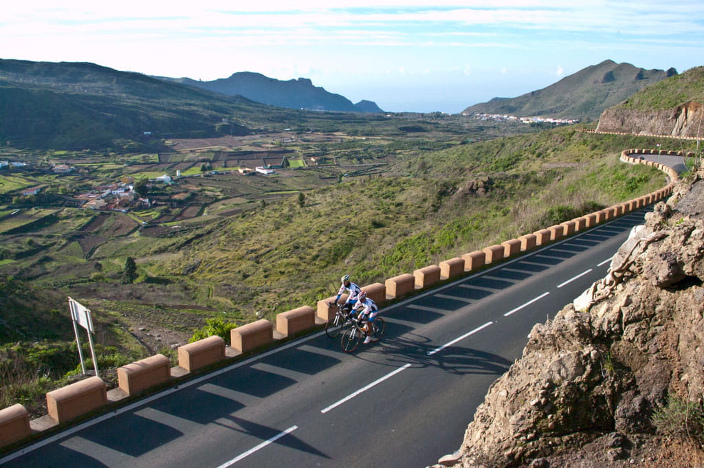 Cyclists on winding road in the mountainous landscape of Tenerife.