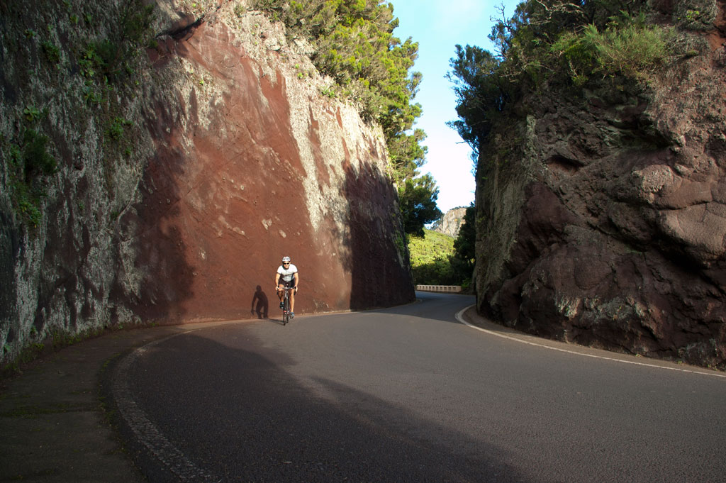 Cyclist on the road surrounded by rock formations in Tenerife.