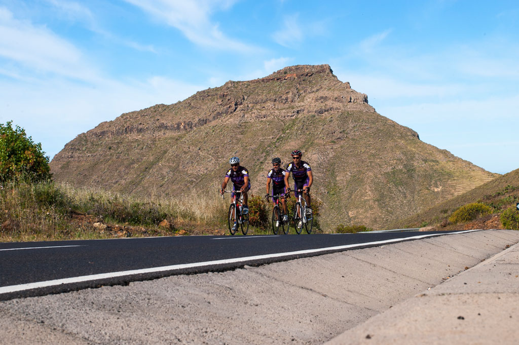 Cyclists on the road near a mountain in Tenerife.