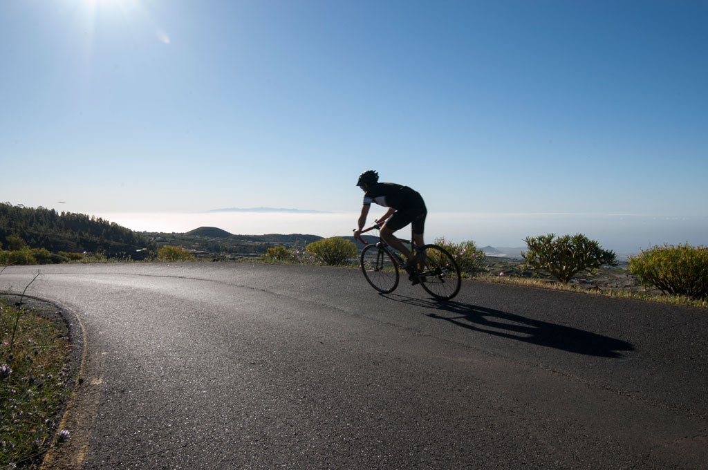 Road cyclist with mountainous landscape and sea view in Tenerife.