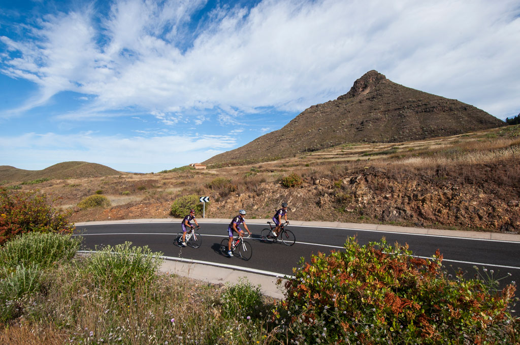 Cyclists on mountainous road near a peak in Tenerife.