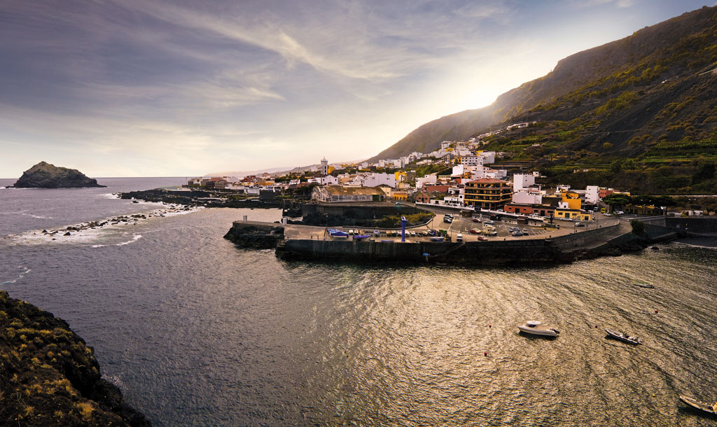 Coastal village by the mountains in Tenerife at sunset.