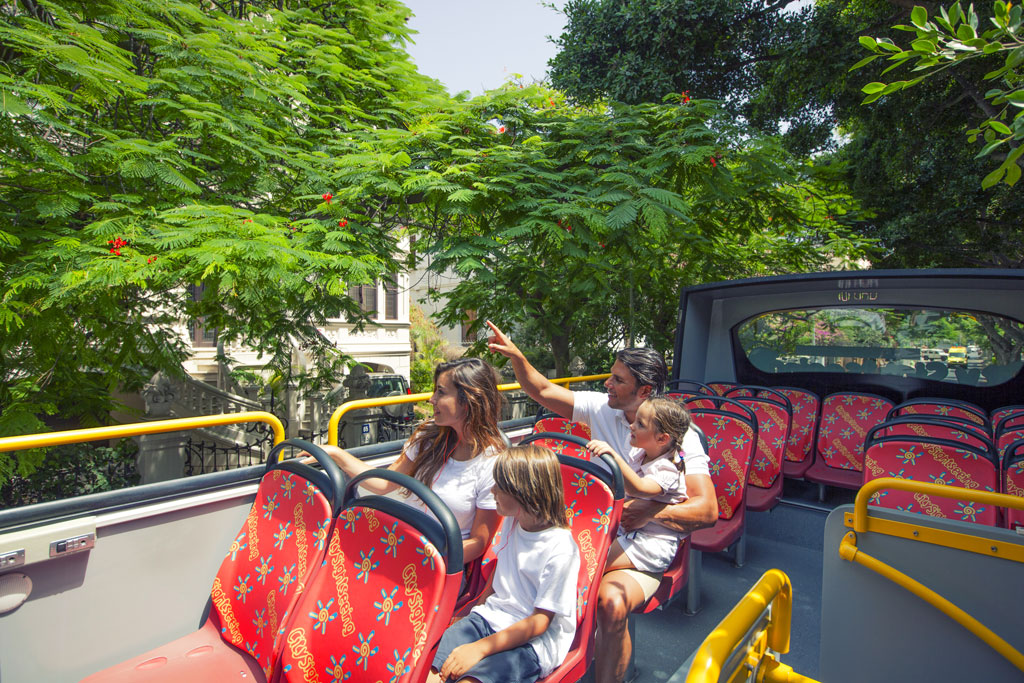 Family enjoys a hop-on hop-off bus tour in Santa Cruz de Tenerife.