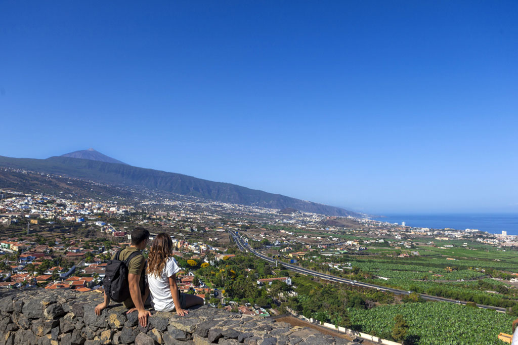 Couple observing the landscape of Mount Teide in Tenerife.