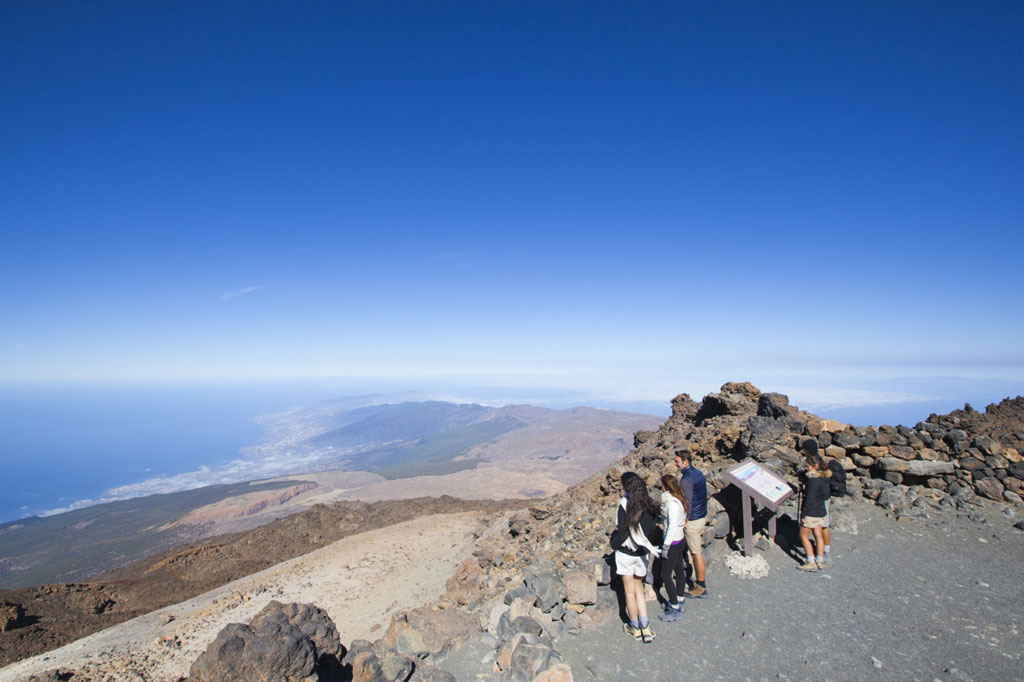 People observe scenery from viewpoint in Teide National Park, Tenerife.