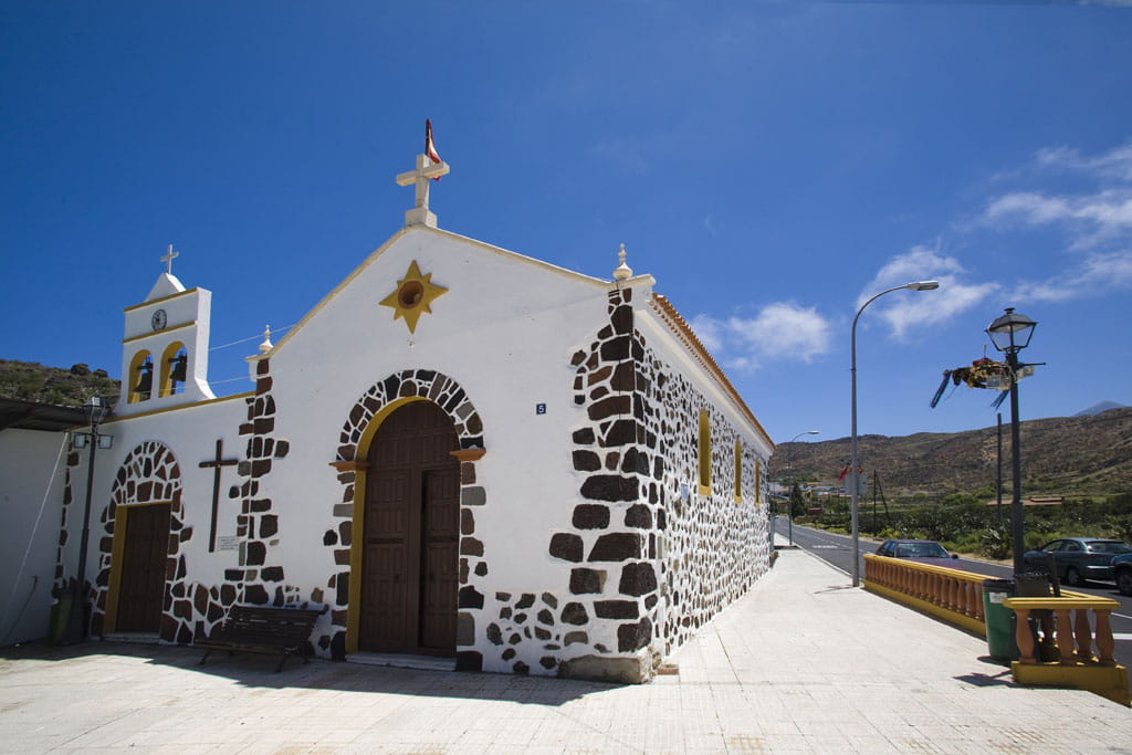 Stone church with crosses and bell tower in a village in Tenerife.