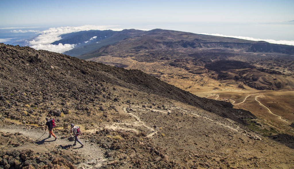 Hikers in the volcanic landscape of Teide National Park, Tenerife.