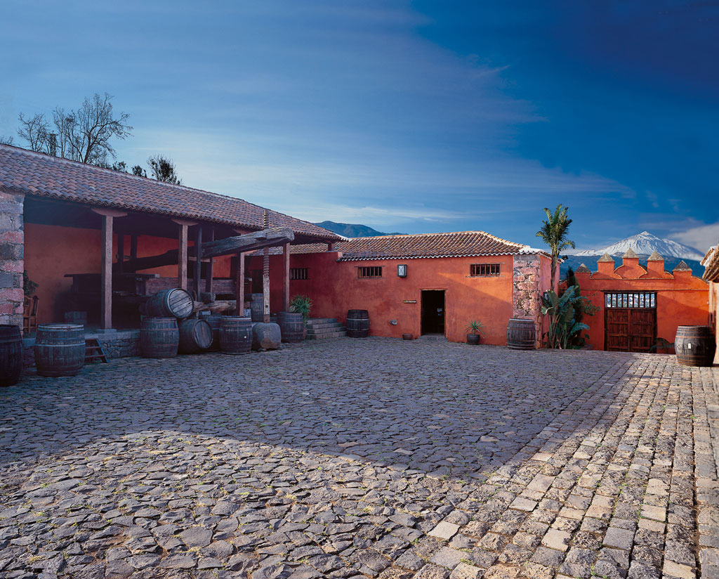 Patio of a traditional winery in Tenerife with barrels and views of Mount Teide.