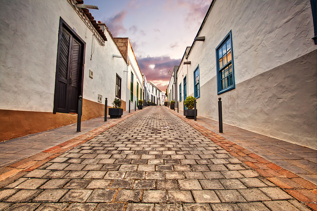 Cobbled street with traditional houses in La Laguna, Tenerife, at sunset.
