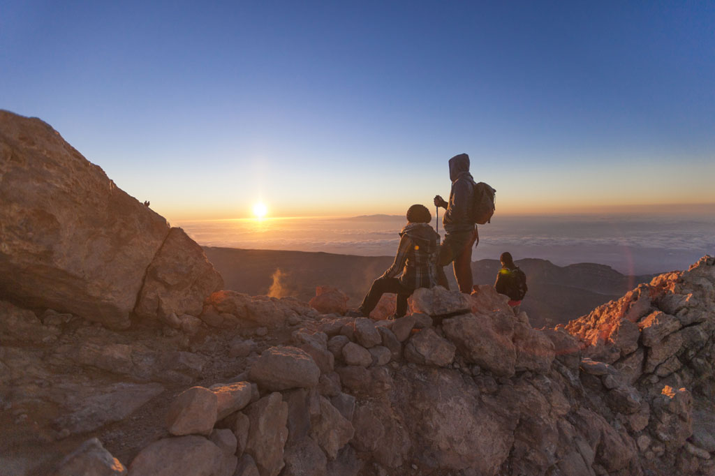 Hikers watching the sunrise from the Pico del Teide in Tenerife.