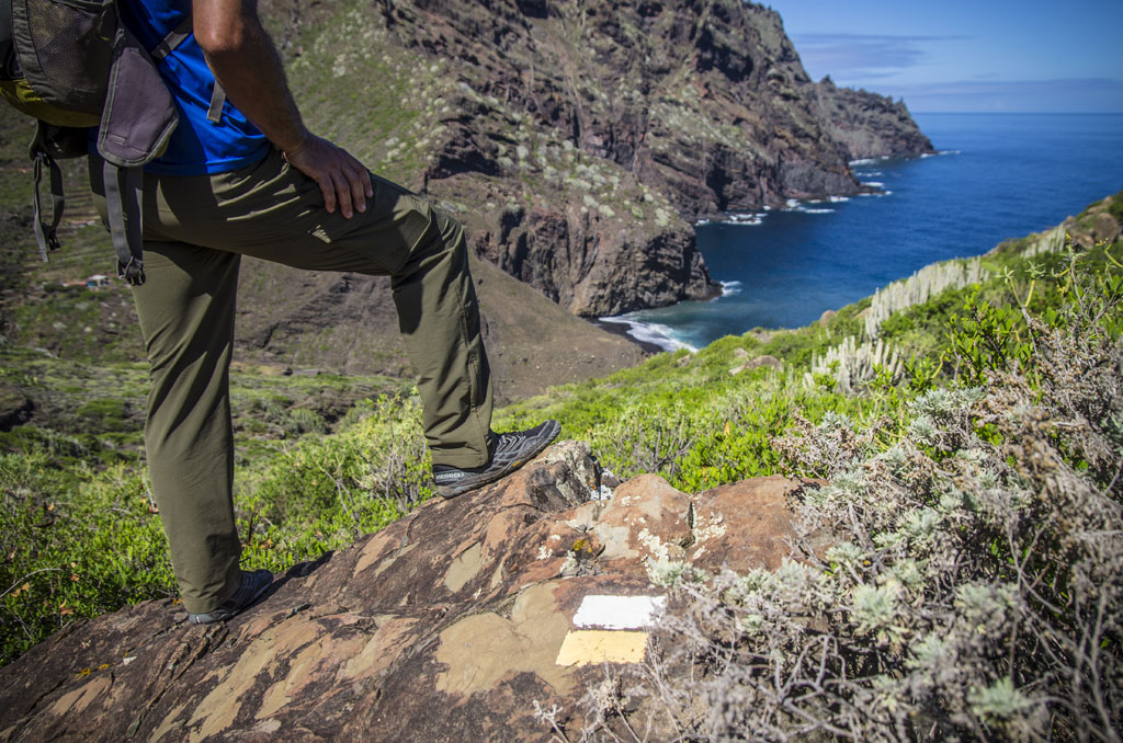 Hiker in front of the ocean and cliffs in Tenerife.