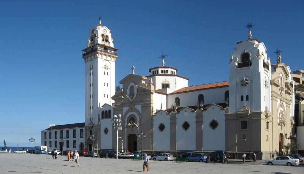 Basilica of La Candelaria in Tenerife with clear skies and people around.