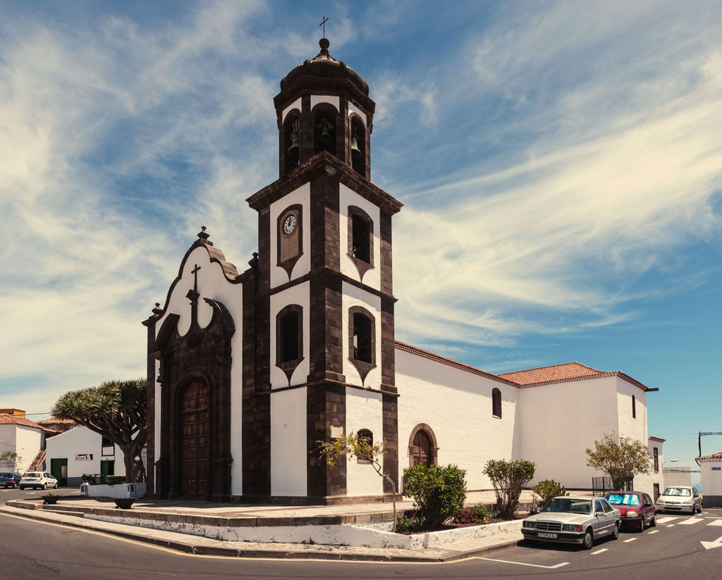 Church in Garachico, Tenerife, with clear skies and trees all around.