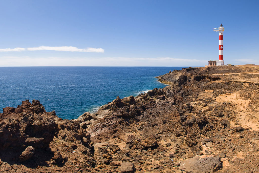 Punta de Teno Lighthouse on the rocky coast of Tenerife, next to the Atlantic Ocean.