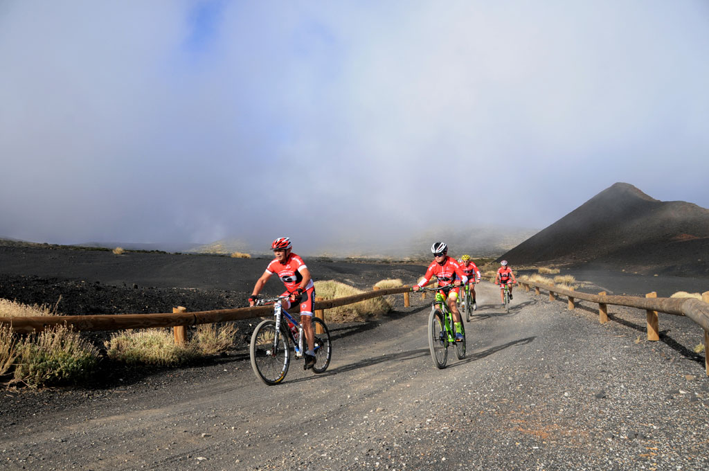 Cyclists on a volcanic route in Tenerife.