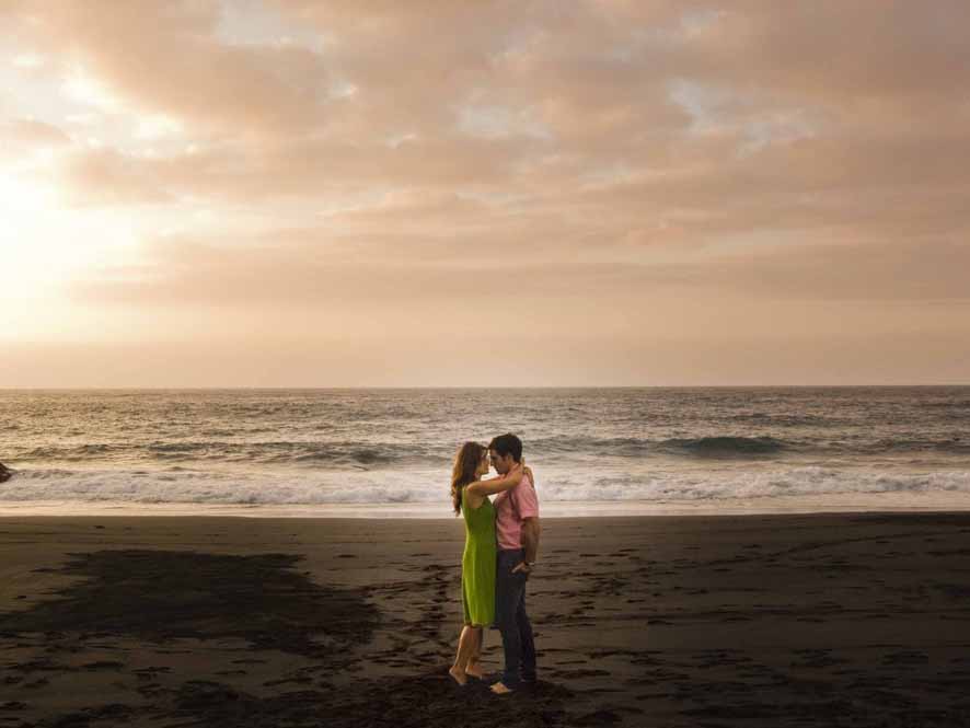 Couple hugging at sunset on a beach in Tenerife.