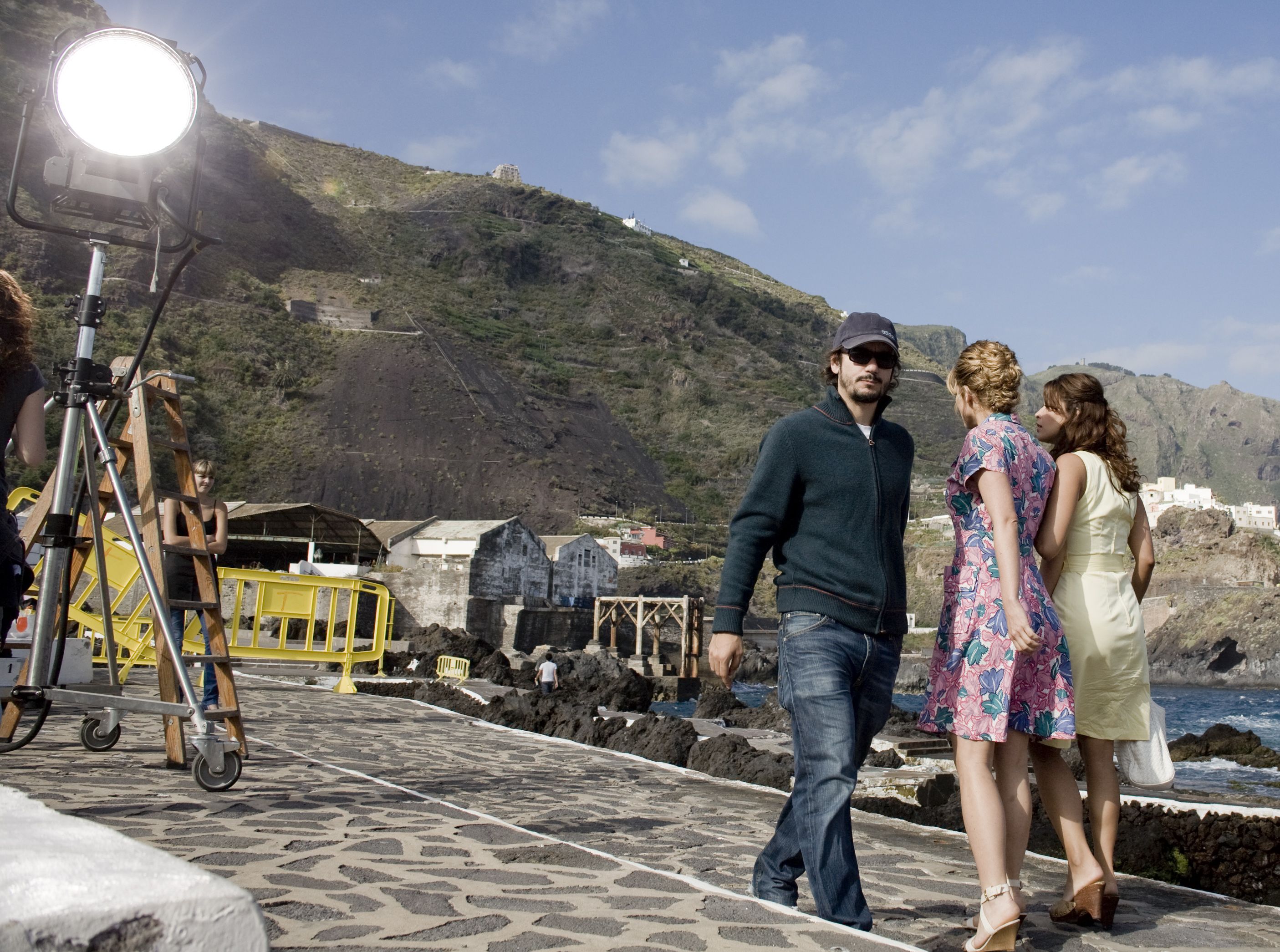 People on a shoot in Garachico, Tenerife, with film crew and mountainous landscape.