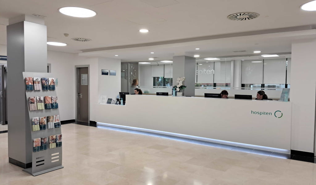 Reception of Hospiten hospital in Tenerife with counter and brochures.