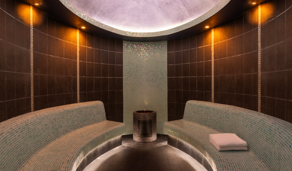 Sauna room with tiled walls and curved benches in Tenerife.