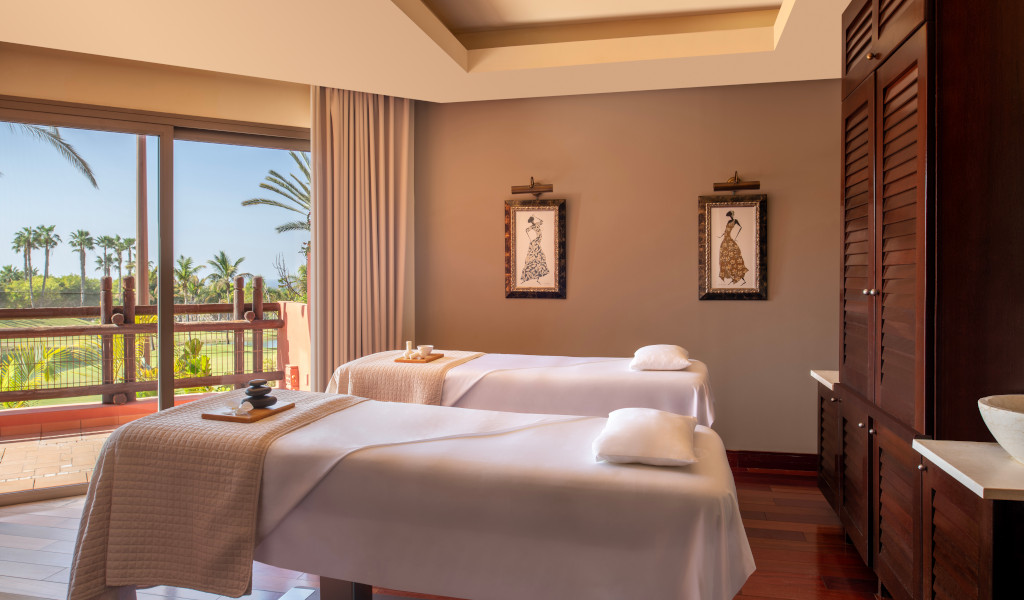 Massage room with two beds and exterior view in Tenerife.
