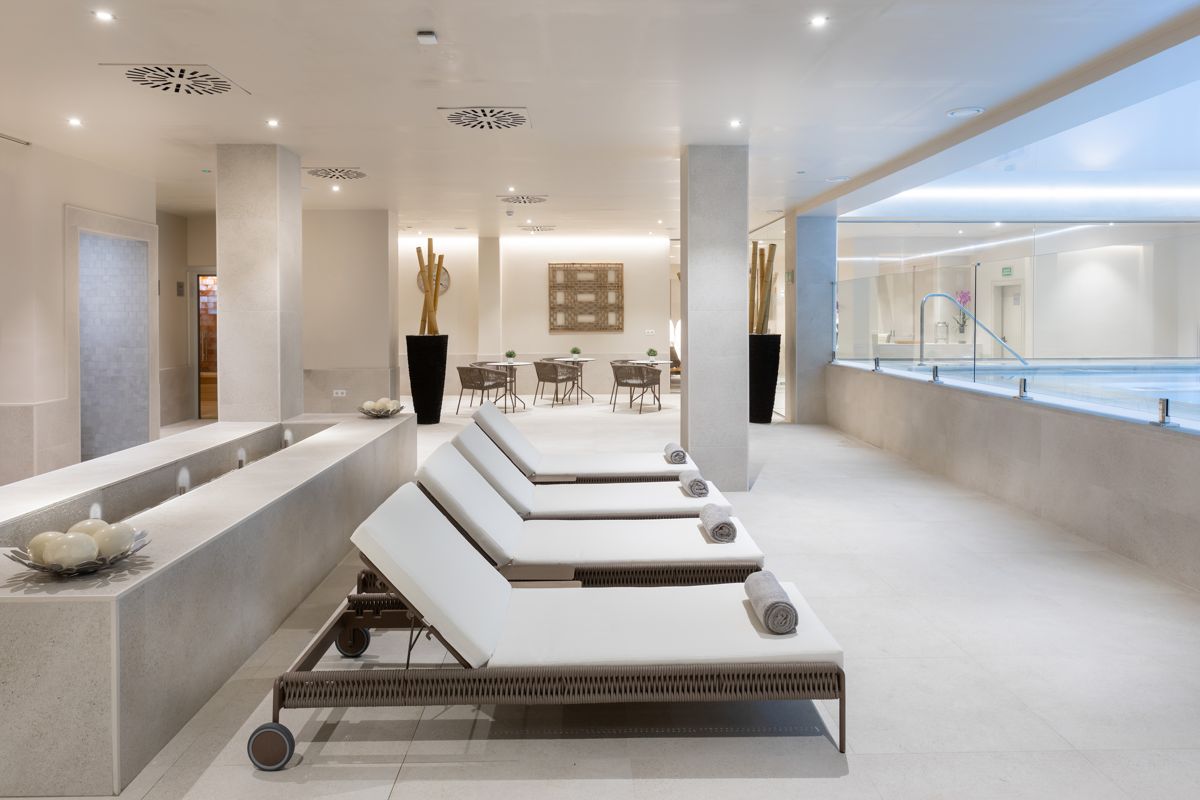 Lounge chairs next to an indoor pool in a spa in Tenerife.