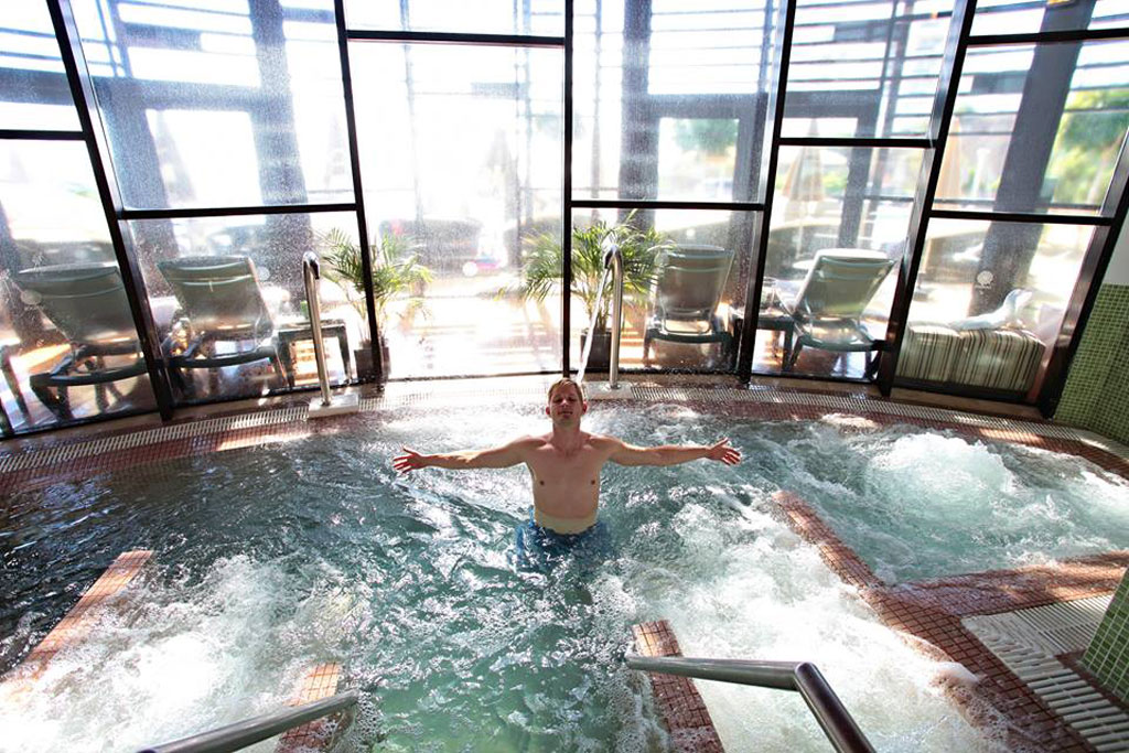 Person enjoying a whirlpool in Tenerife spa.