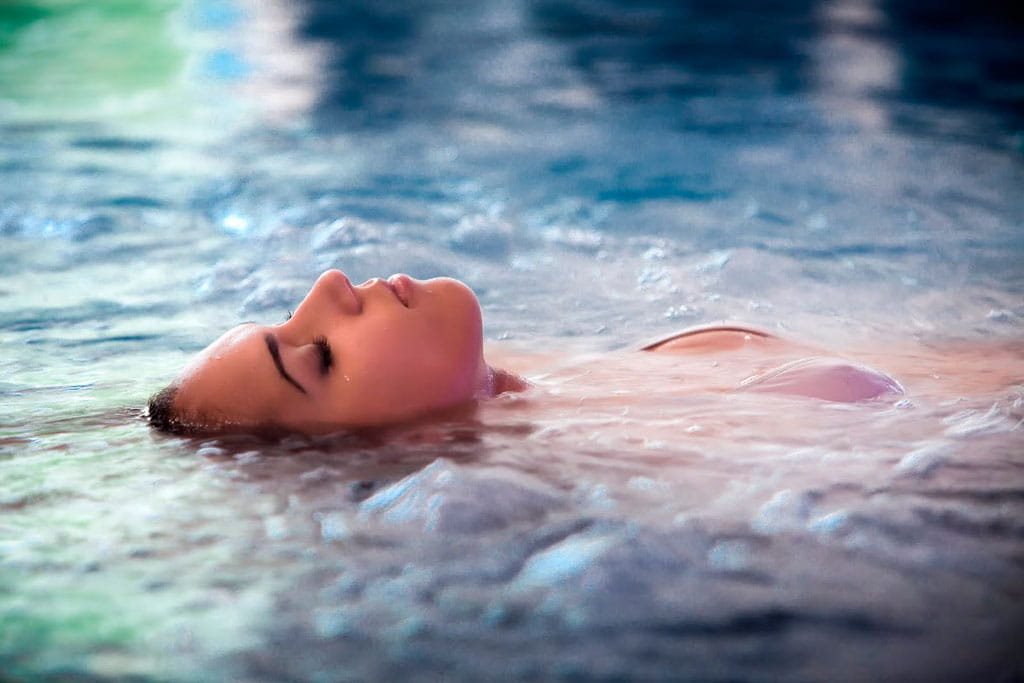 Person floating on his back in the water at a spa in Tenerife.