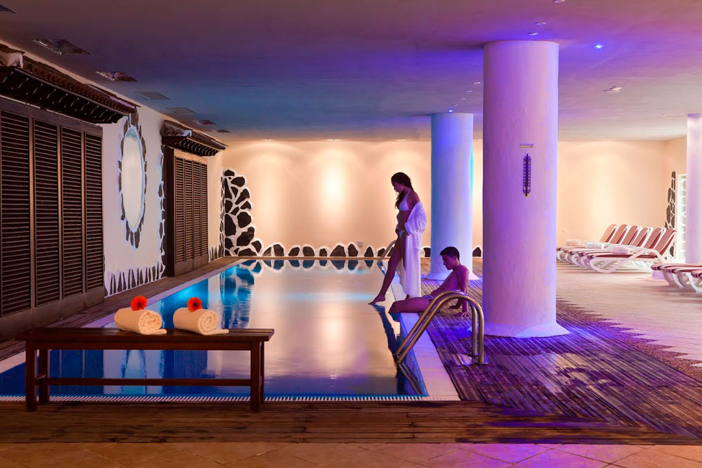 Indoor pool with dim lighting in a spa in Tenerife.