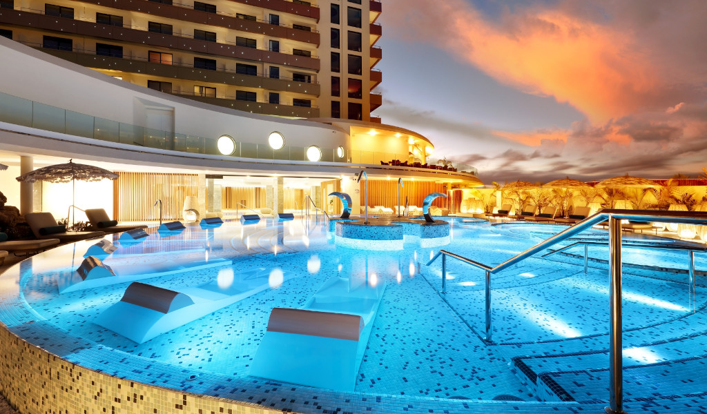 Swimming pool illuminated at dusk in a hotel in Tenerife.