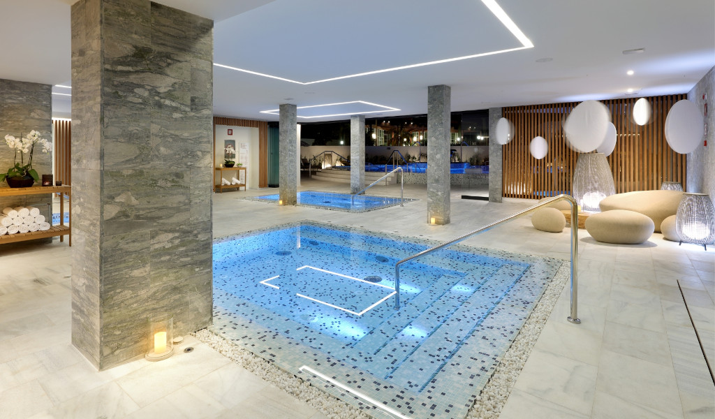 Modern spa with illuminated pools and towels on shelves, Santa Cruz de Tenerife.