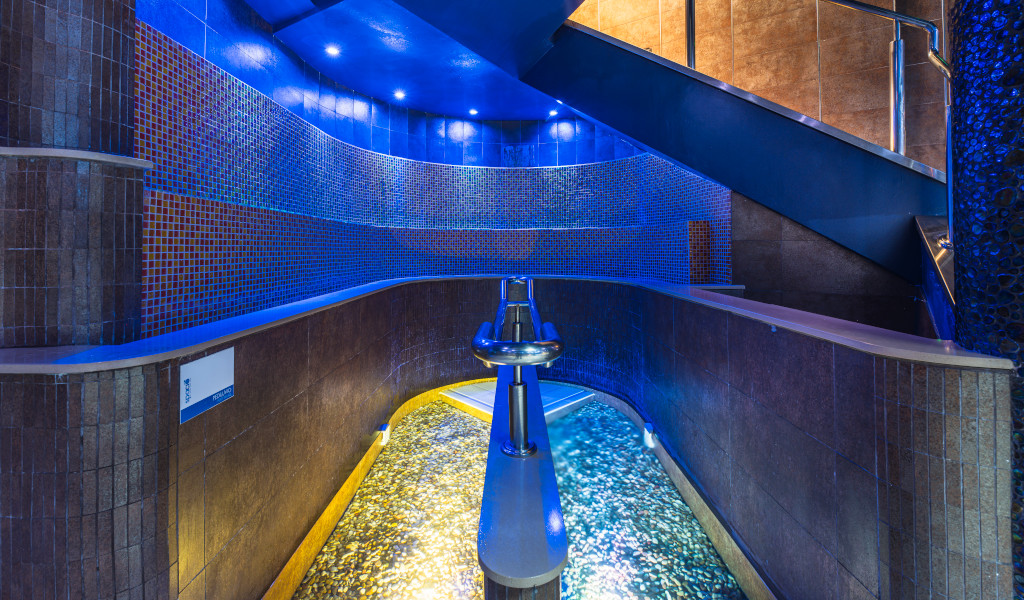 Curved path with water and illuminated blue mosaics, located in Tenerife.