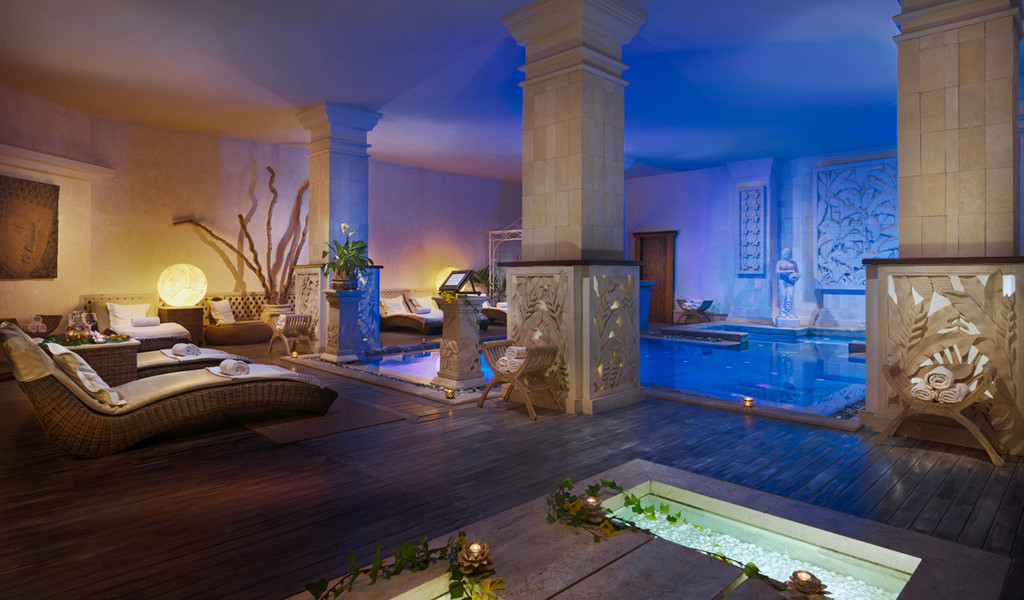 Indoor spa area with swimming pool and sun loungers in Tenerife.