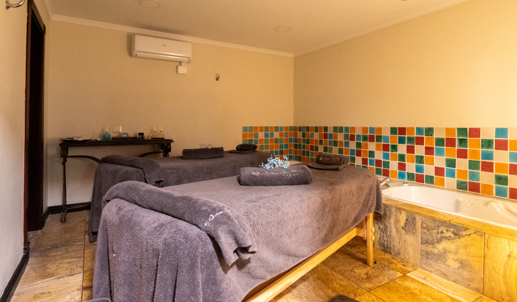 Massage room with two tables and bathtub in a spa in Tenerife.
