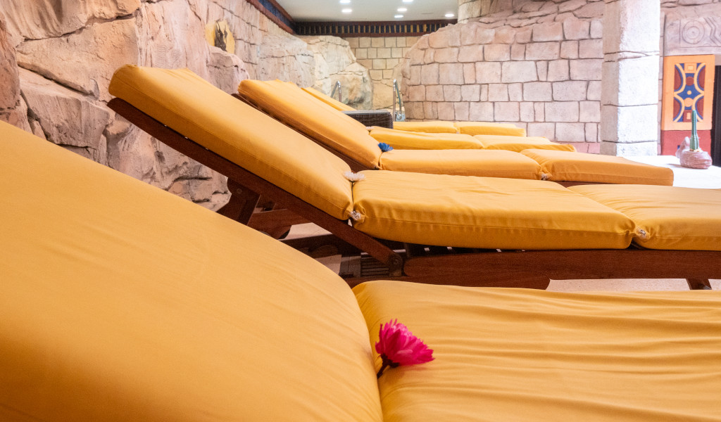 Yellow sun loungers next to a stone wall in a spa in Costa Adeje, Tenerife.