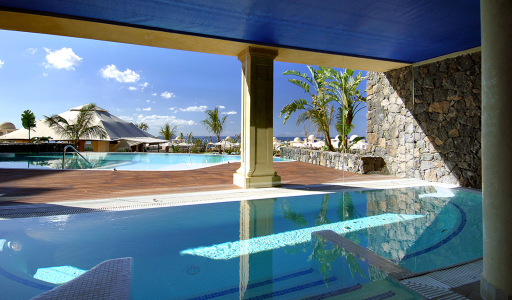Outdoor swimming pools with palm trees in Tenerife.