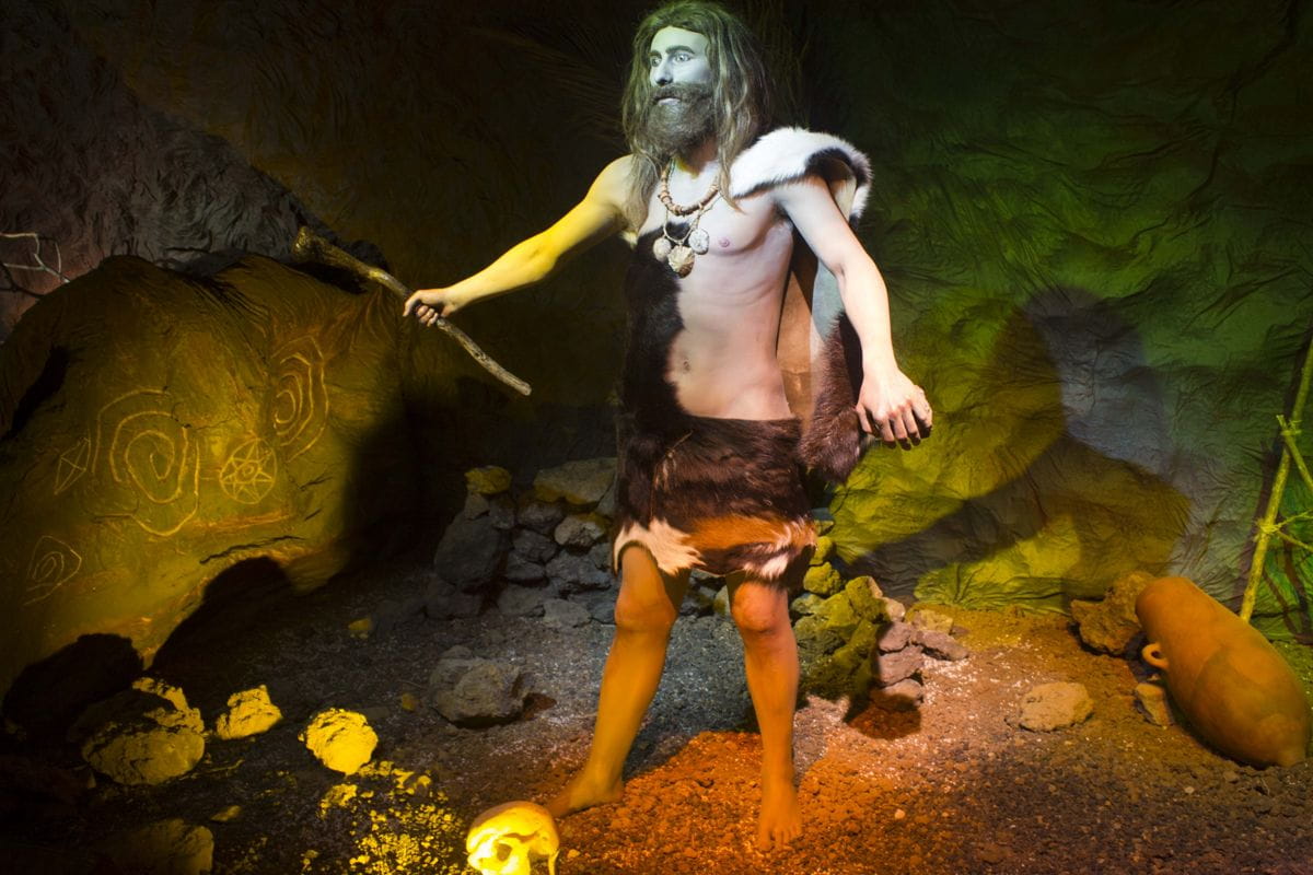 Prehistoric man in fur clothing in a cave, Tenerife.