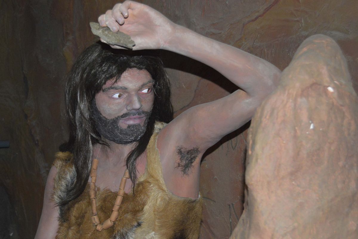 Figure of a prehistoric man with stone in hand in Santa Cruz de Tenerife.