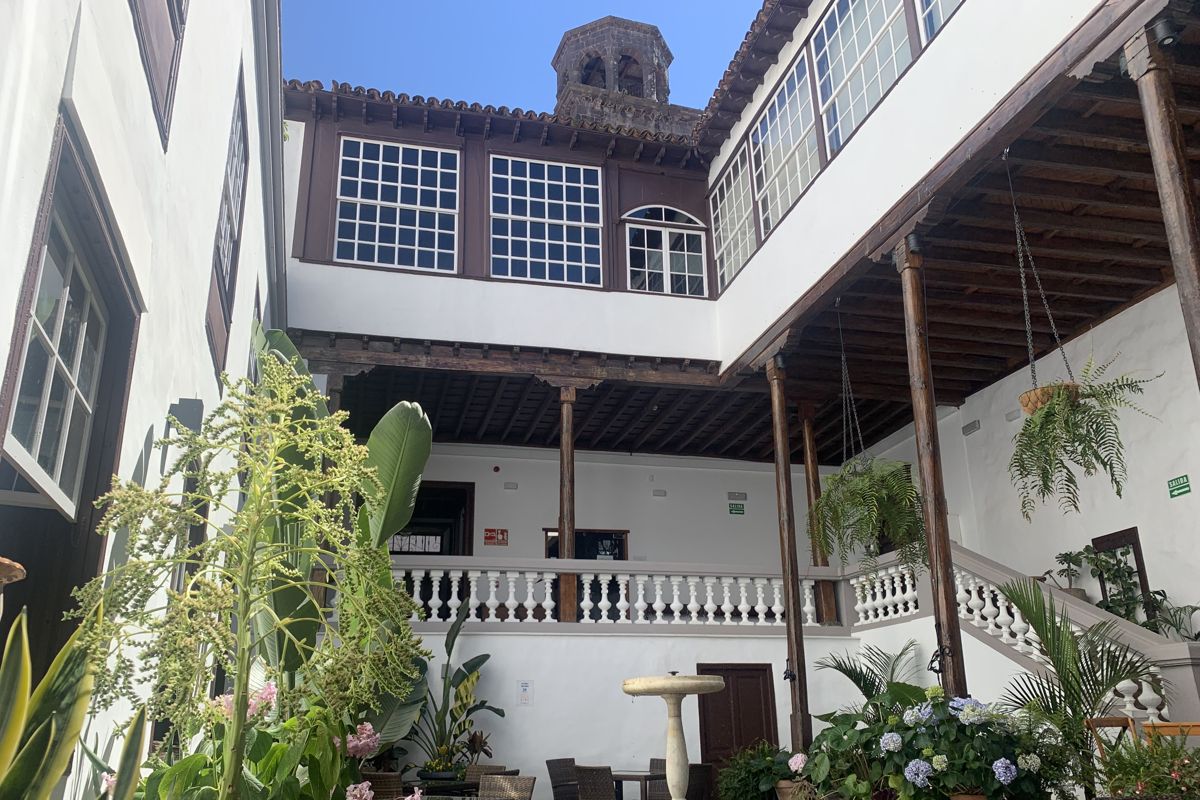 Interior courtyard with plants and stairs in historic building of Tenerife.