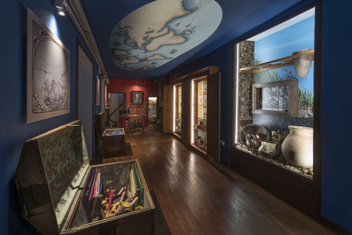 Exhibition of ancient objects and maps in a museum room in Tenerife.