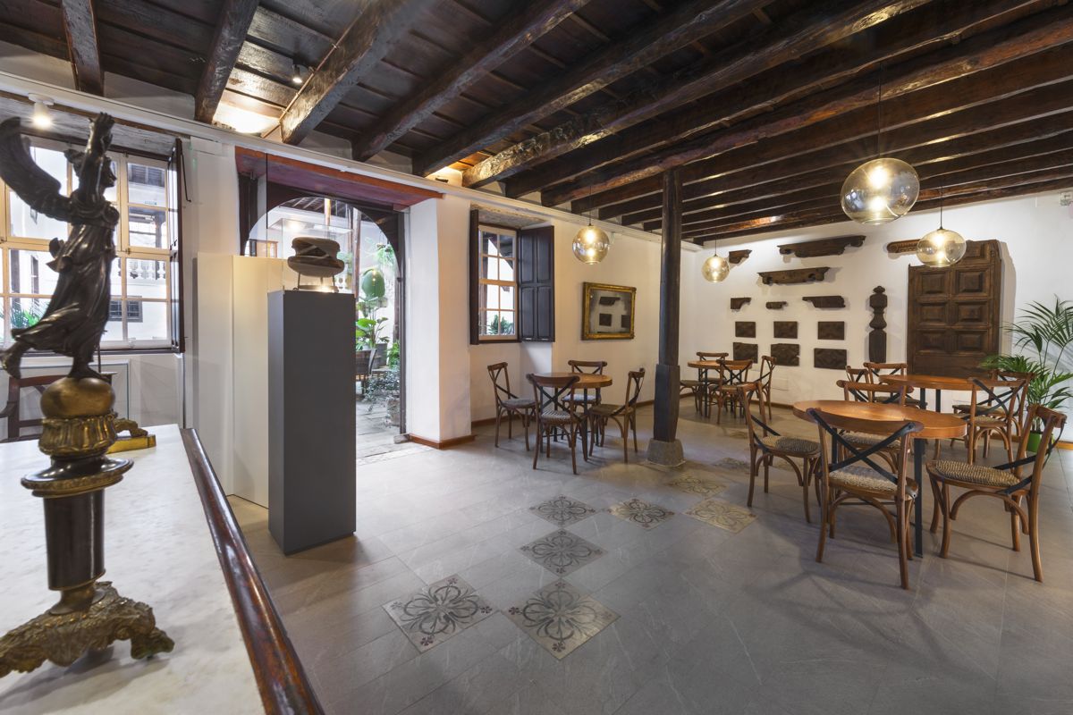 Interior of a historic café in Tenerife with wooden tables and classic décor.
