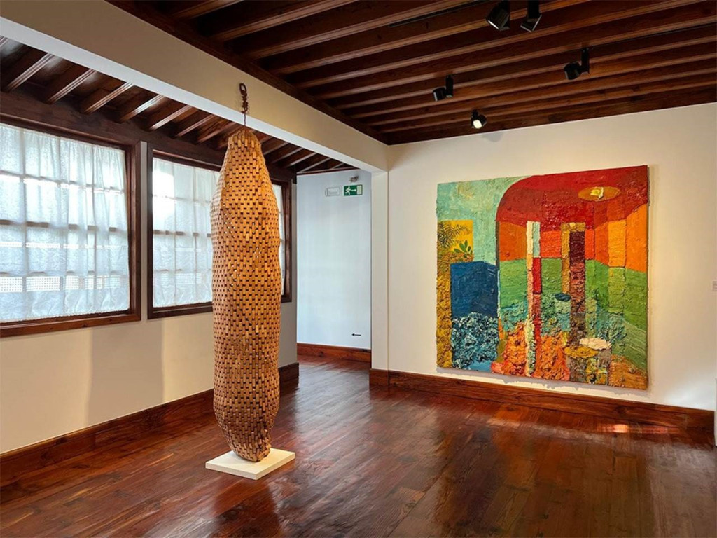 Wooden sculpture and abstract painting in art room in Tenerife.