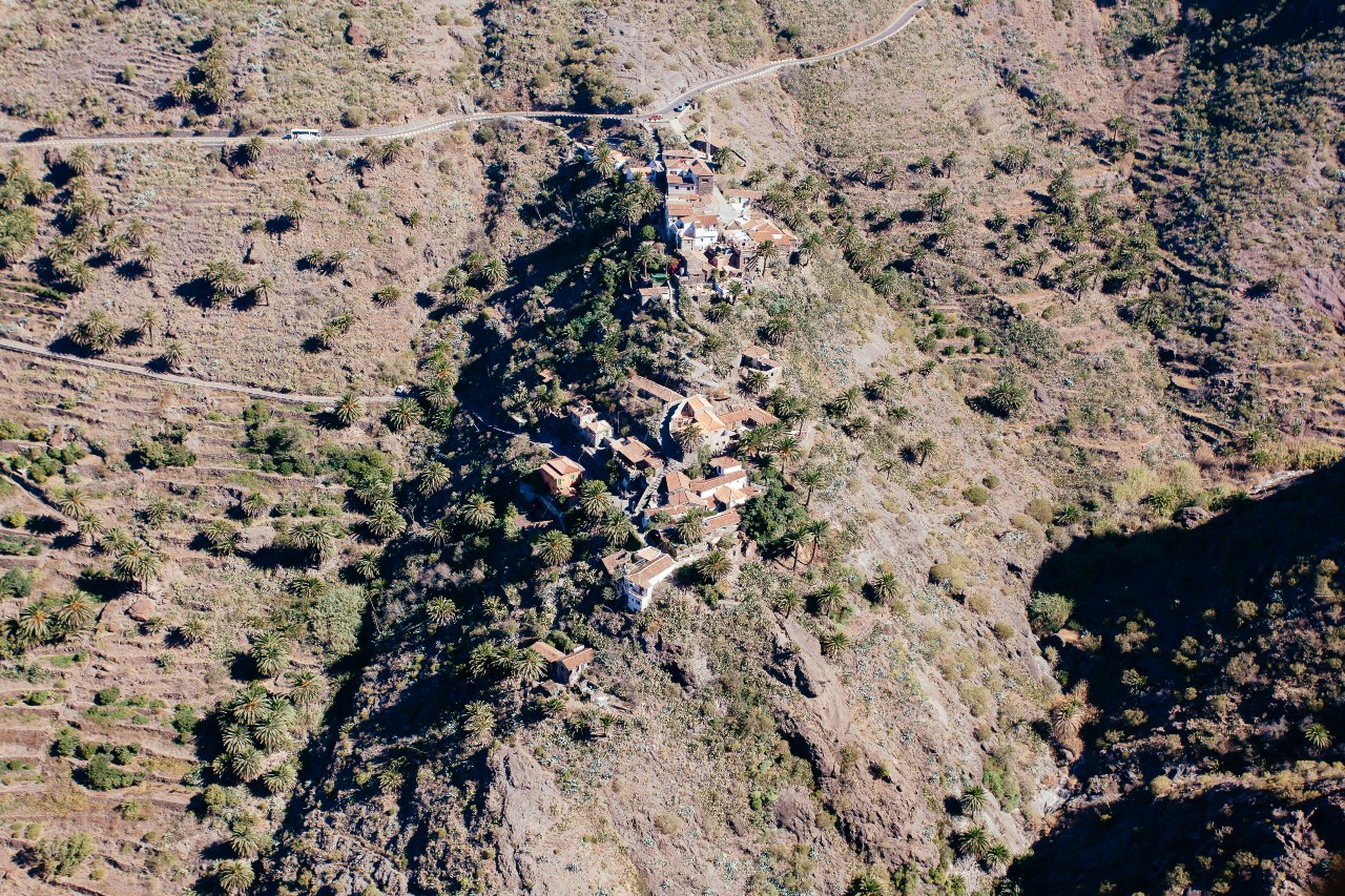 Aerial view of Taganana in Tenerife, surrounded by mountains and scattered vegetation.