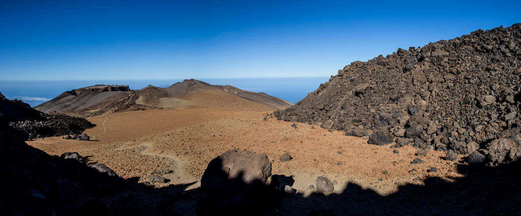Volcanic landscape on Mount Teide, Tenerife, with clear skies and visible horizons.